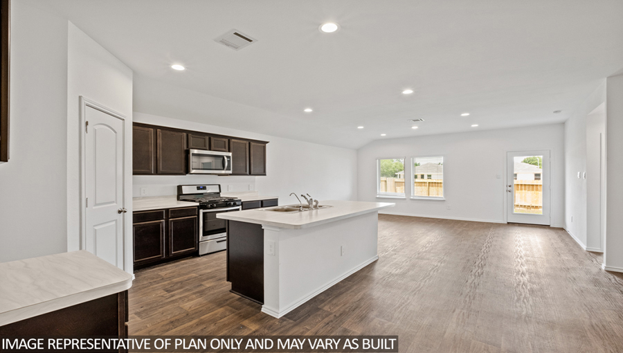 Kitchen with an island and vinyl floor