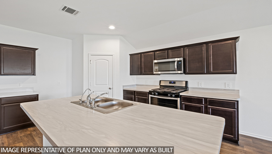 Kitchen with an island and vinyl floor