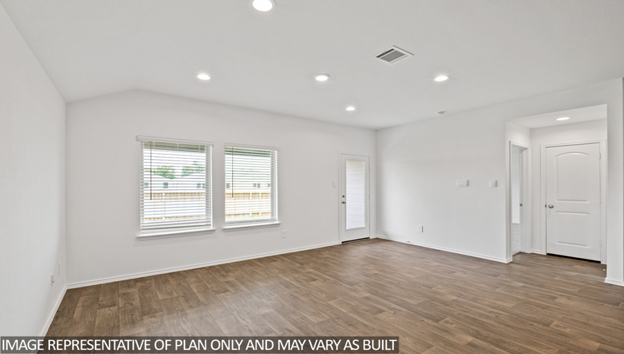 Spacious living area with vinyl flooring
