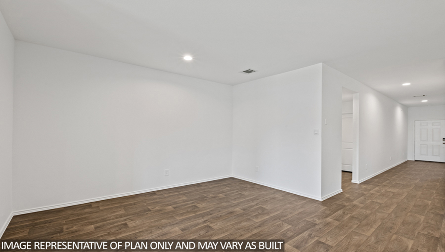 Spacious living area with vinyl flooring