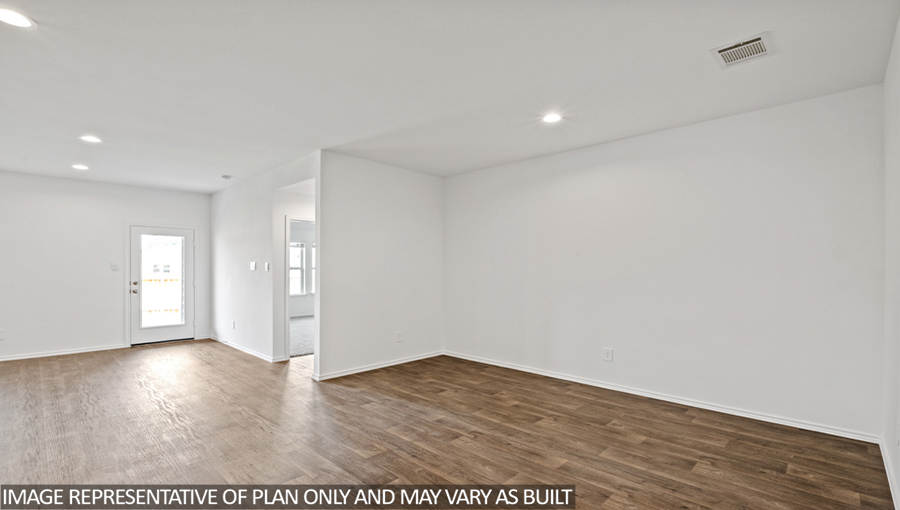 Spacious living area with vinyl flooring