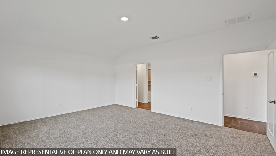 Primary bedroom with carpet flooring