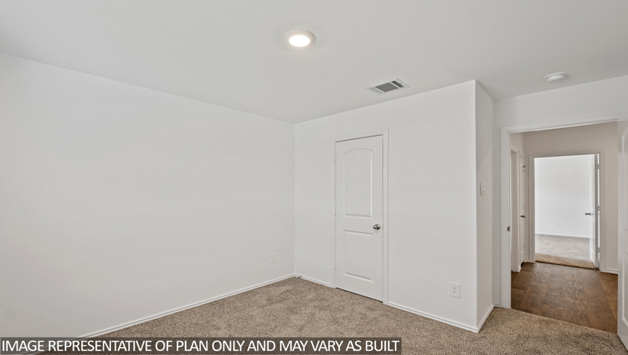 Secondary bedroom with carpet flooring