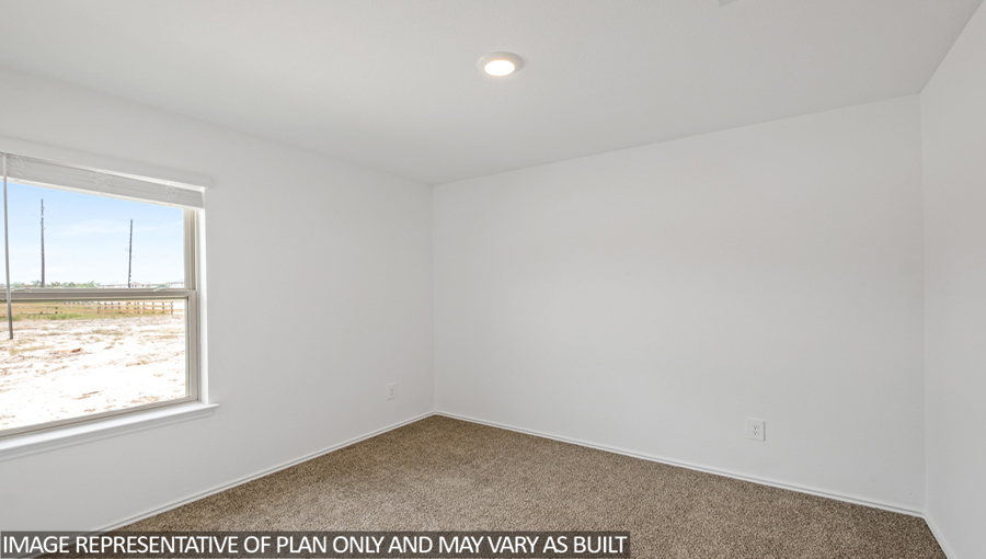 Secondary bedroom with carpet flooring