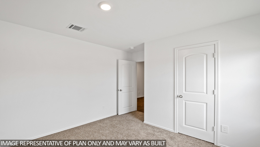Secondary bedroom with carpet flooring
