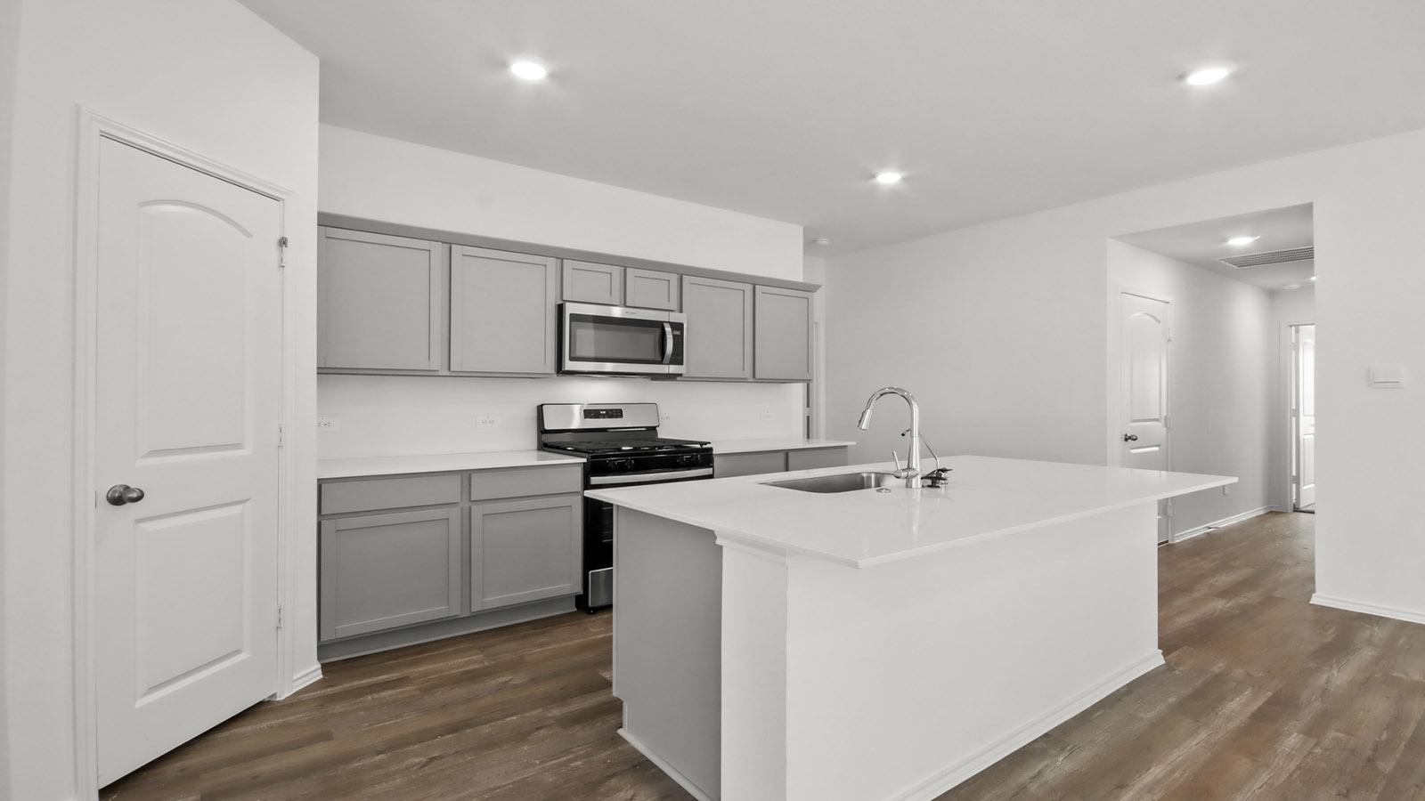 open concept living and dining area with vinyl flooring, quartz counertops, and large windows