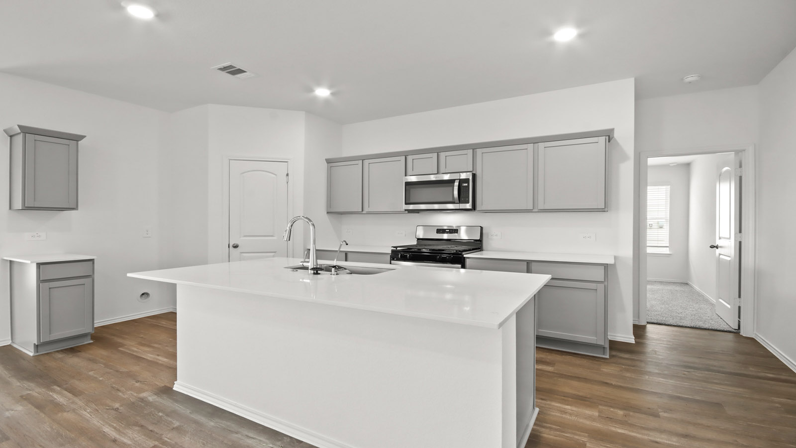 open concept living and dining area with vinyl flooring, quartz counertops, and large windows