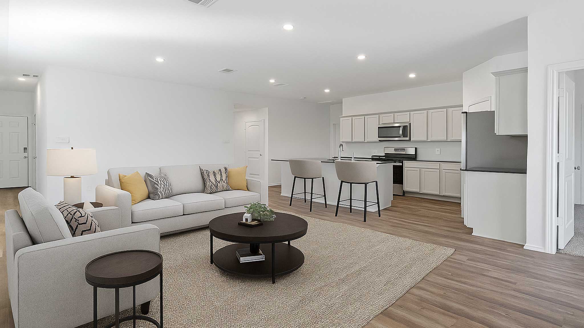 open concept living and dining area with vinyl flooring, quartz counertops, and large windows