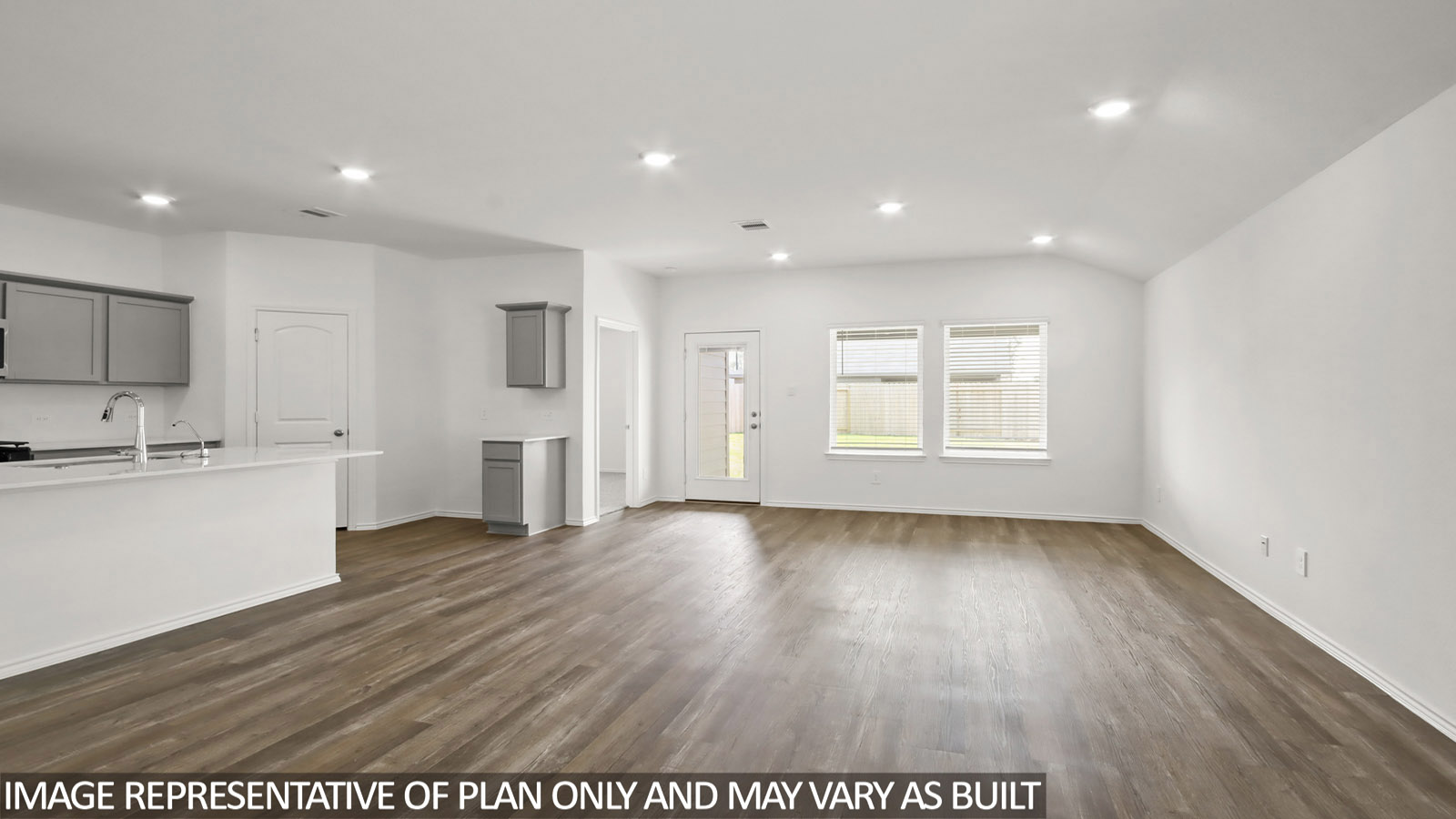 open concept living and dining area with vinyl flooring, large windows, and quartz countertops