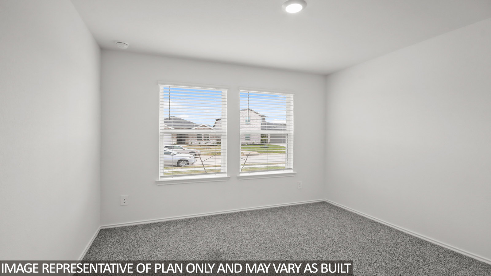 Secondary bedroom with carpet flooring