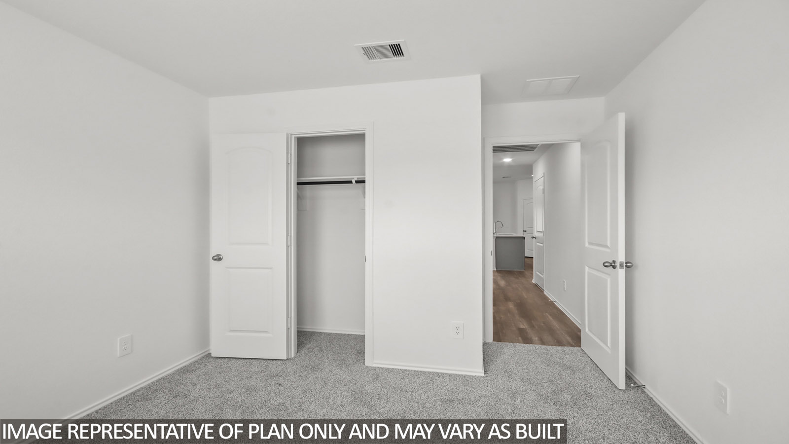 Secondary bedroom with carpet flooring
