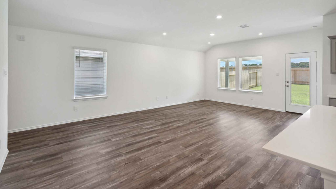 open concept living and dining area with vinyl flooring, large windows, and quartz countertops