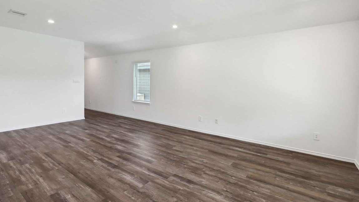 open concept living and dining area with vinyl flooring, large windows, and quartz countertops