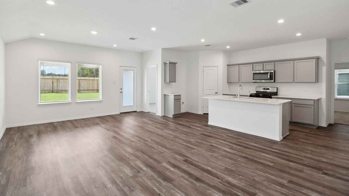 open concept living and dining area with vinyl flooring, large windows, and quartz countertops