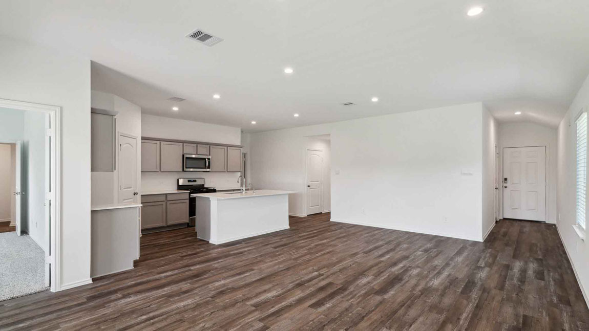 open concept living and dining area with vinyl flooring, large windows, and quartz countertops
