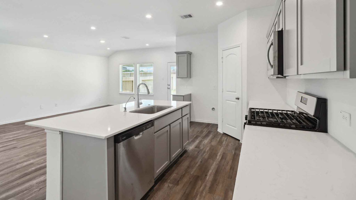 open concept living and dining area with vinyl flooring, large windows, and quartz countertops