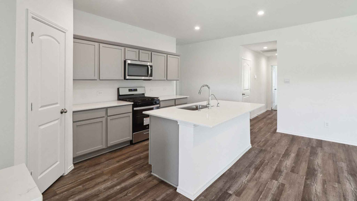 open concept living and dining area with vinyl flooring, large windows, and quartz countertops