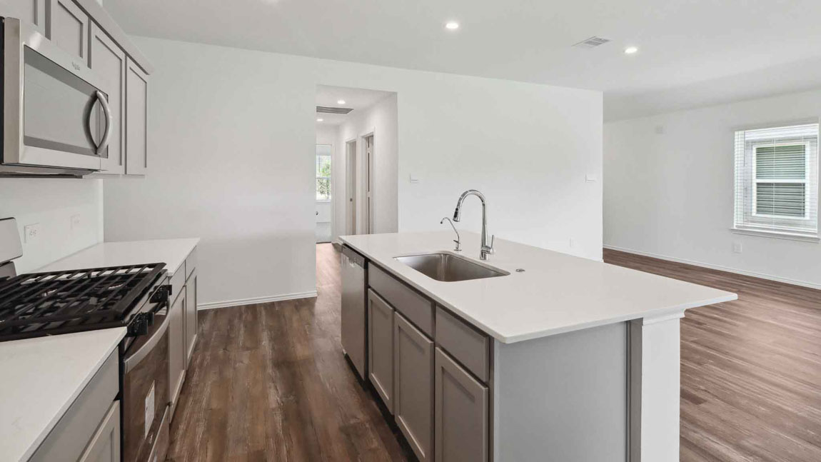 open concept living and dining area with vinyl flooring, large windows, and quartz countertops