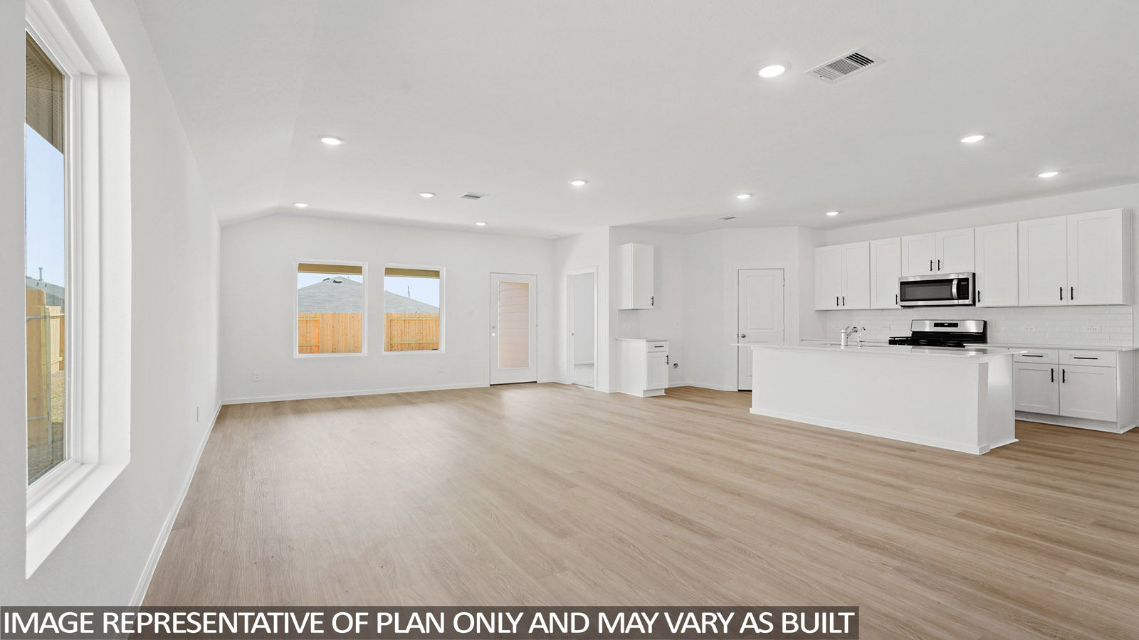 open concept living and dining area with vinyl flooring , quartz countertops, and large windows