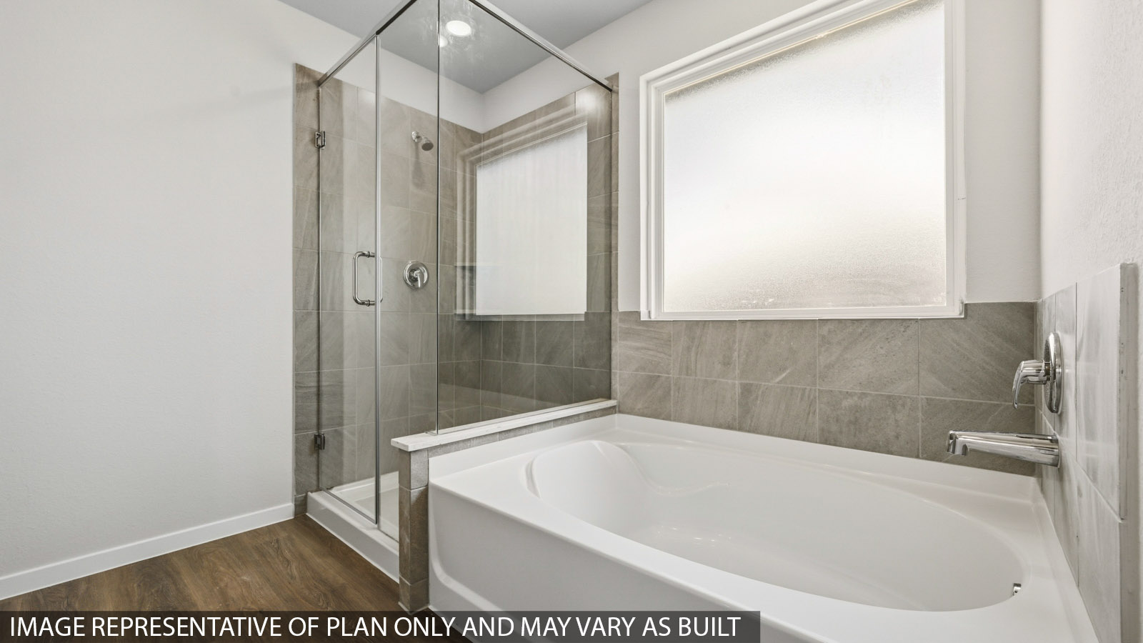 Primary bathroom with a walk-in shower, storage shelves, dual sinks, light gray cabinets, white walls, and vinyl wood flooring.