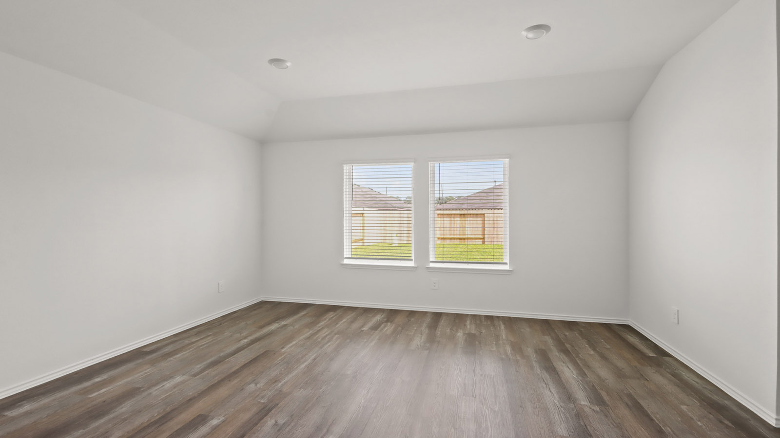 open concept living and dining area with vinl flooring and large windows