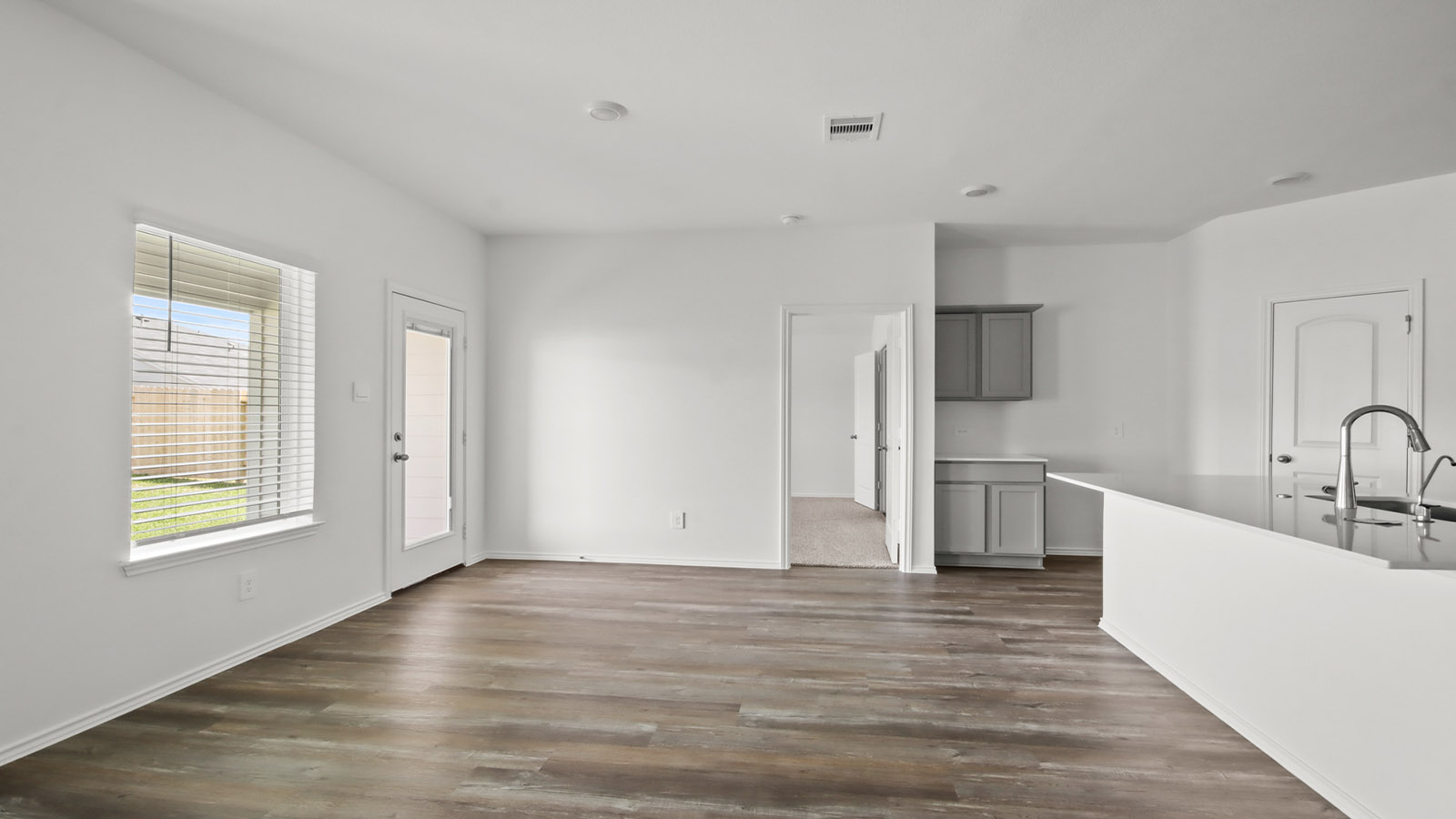 open concept living and dining area with vinl flooring and large windows