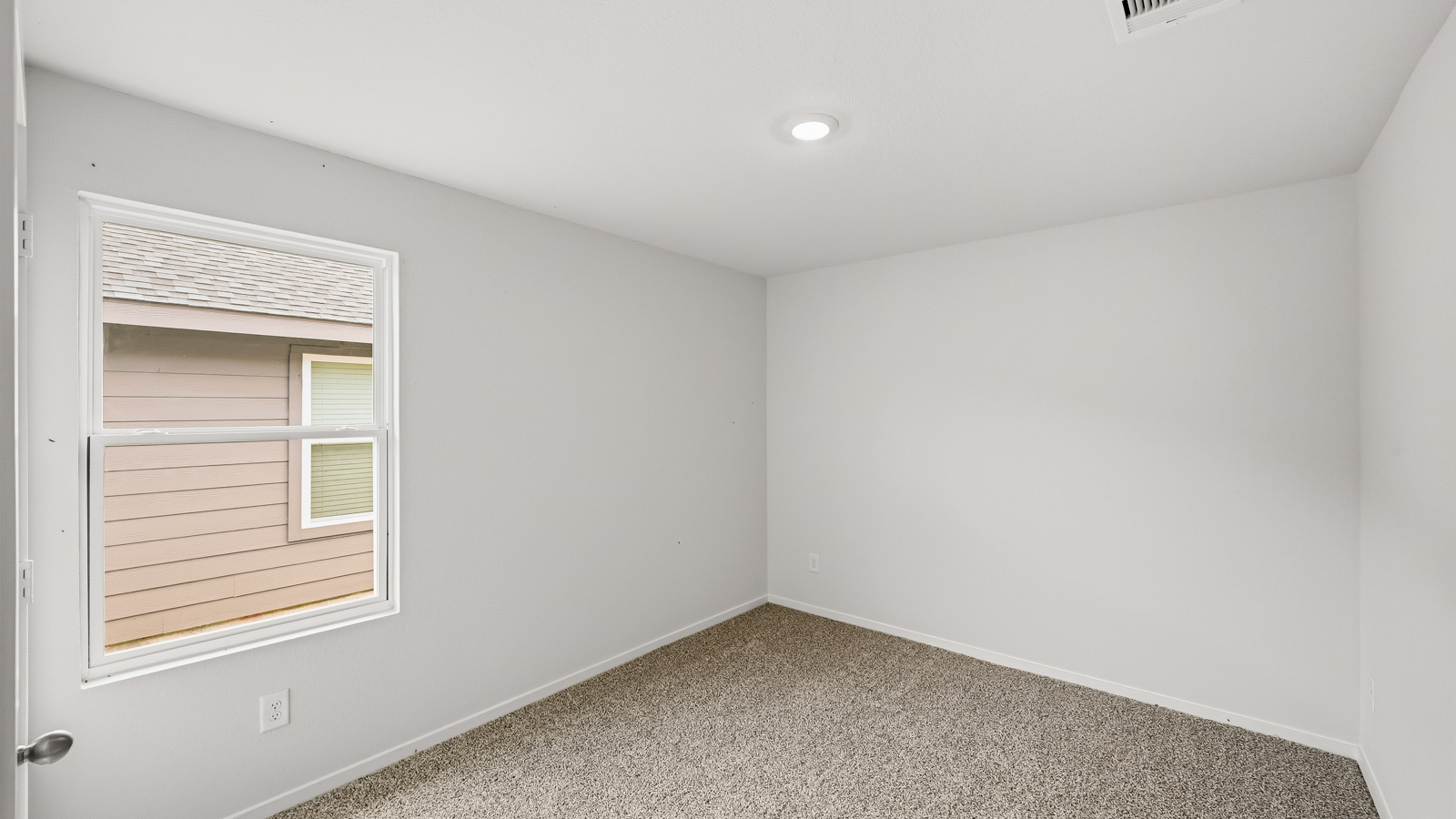 Secondary bedroom with shag carpet flooring and bright window