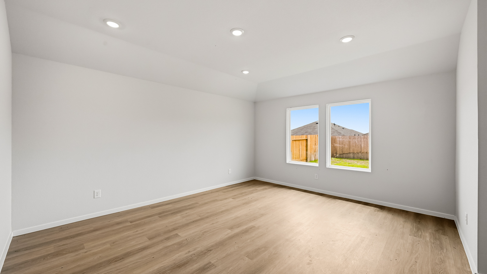 Spacious living area with vinyl flooring and bright windows in Hockley TX