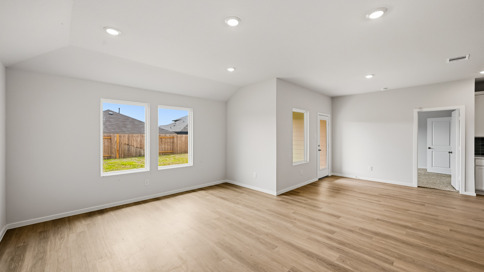 Spacious living area with vinyl flooring and bright windows in Hockley TX