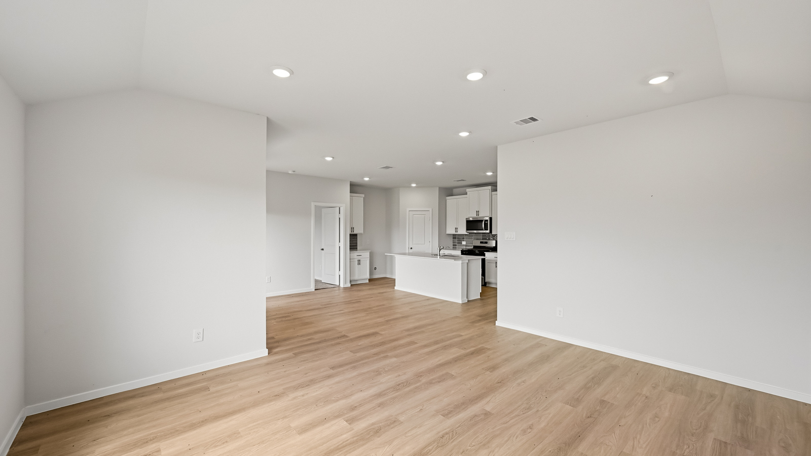 Spacious living area with vinyl flooring and bright windows in Hockley TX