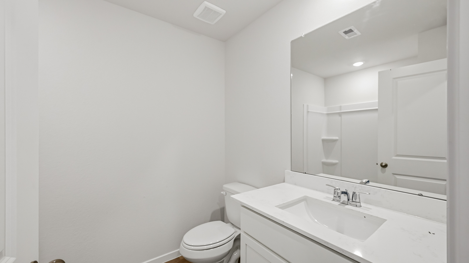 Powder bathroom with pedestal sink right off the foyer entry hallway