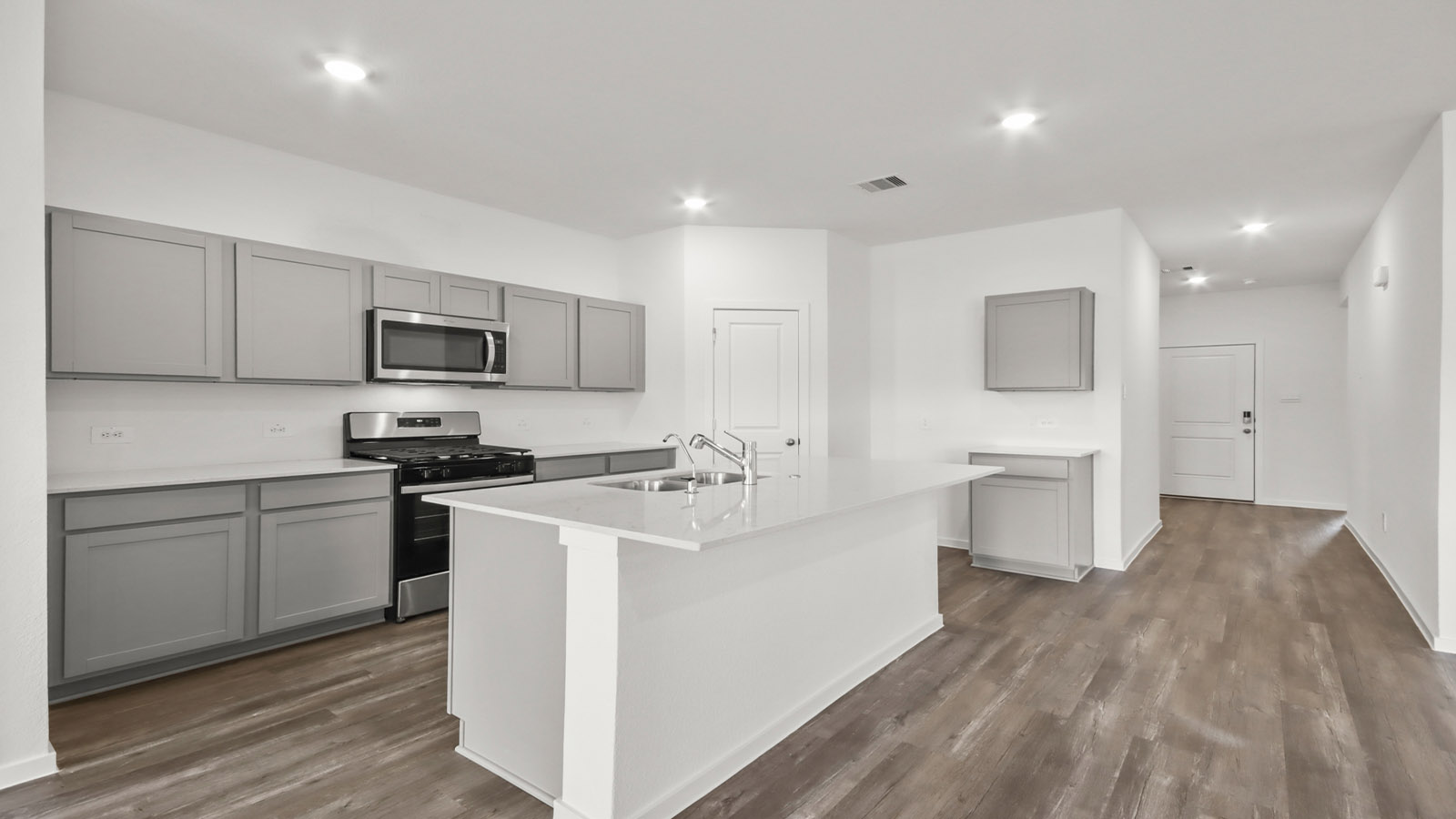 open concept living and dining area with vinyl flooring, quartz countertops, and large windows