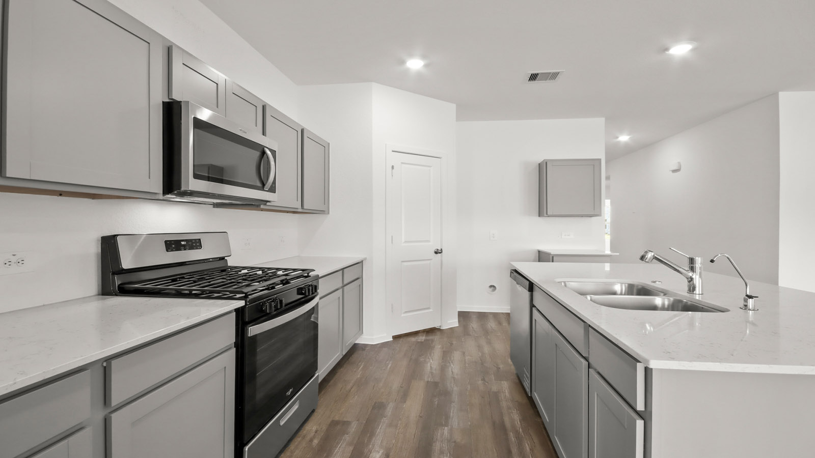open concept living and dining area with vinyl flooring, quartz countertops, and large windows