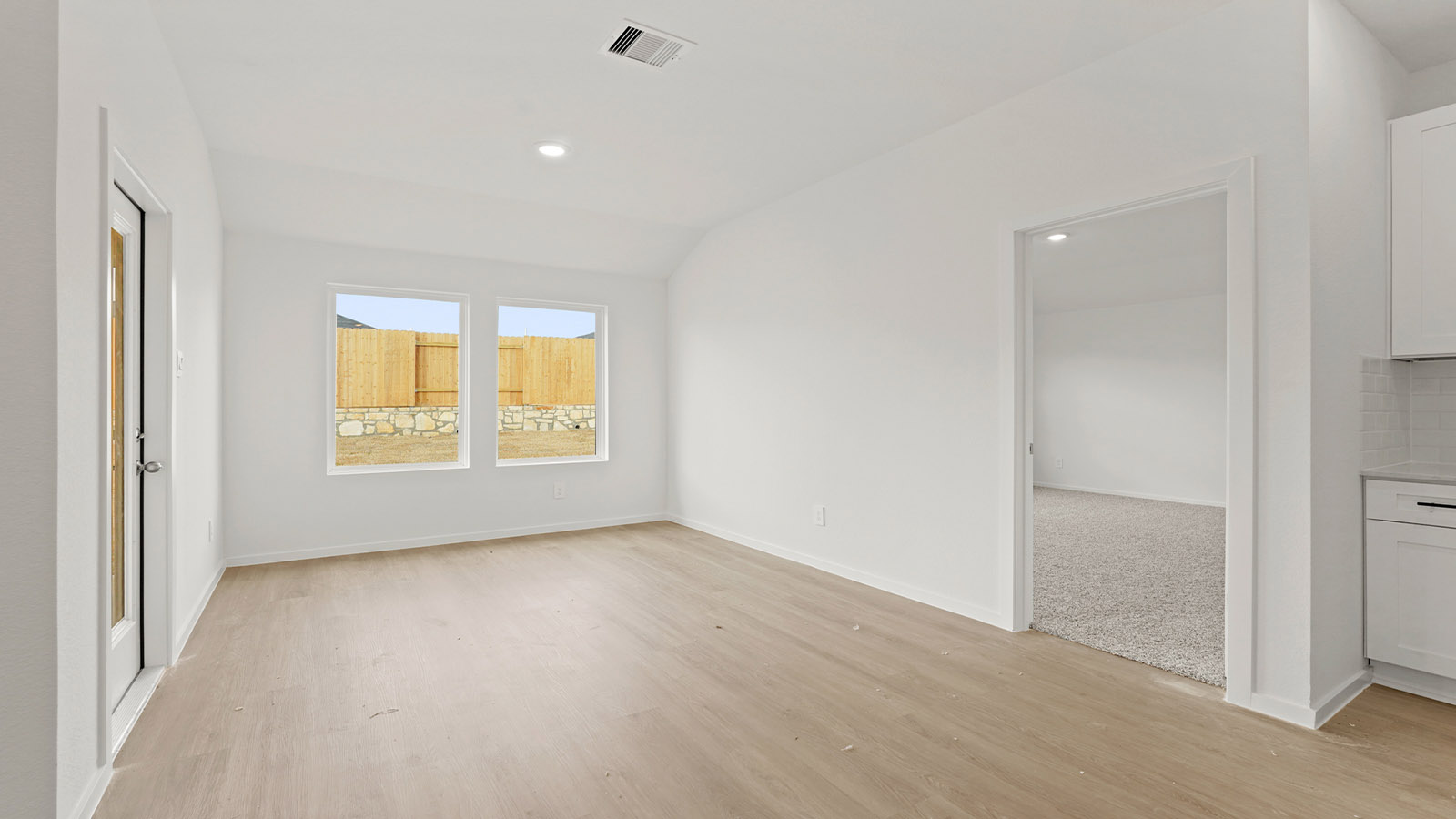 open concept living and dining area with vinyl flooring and quartz countertops