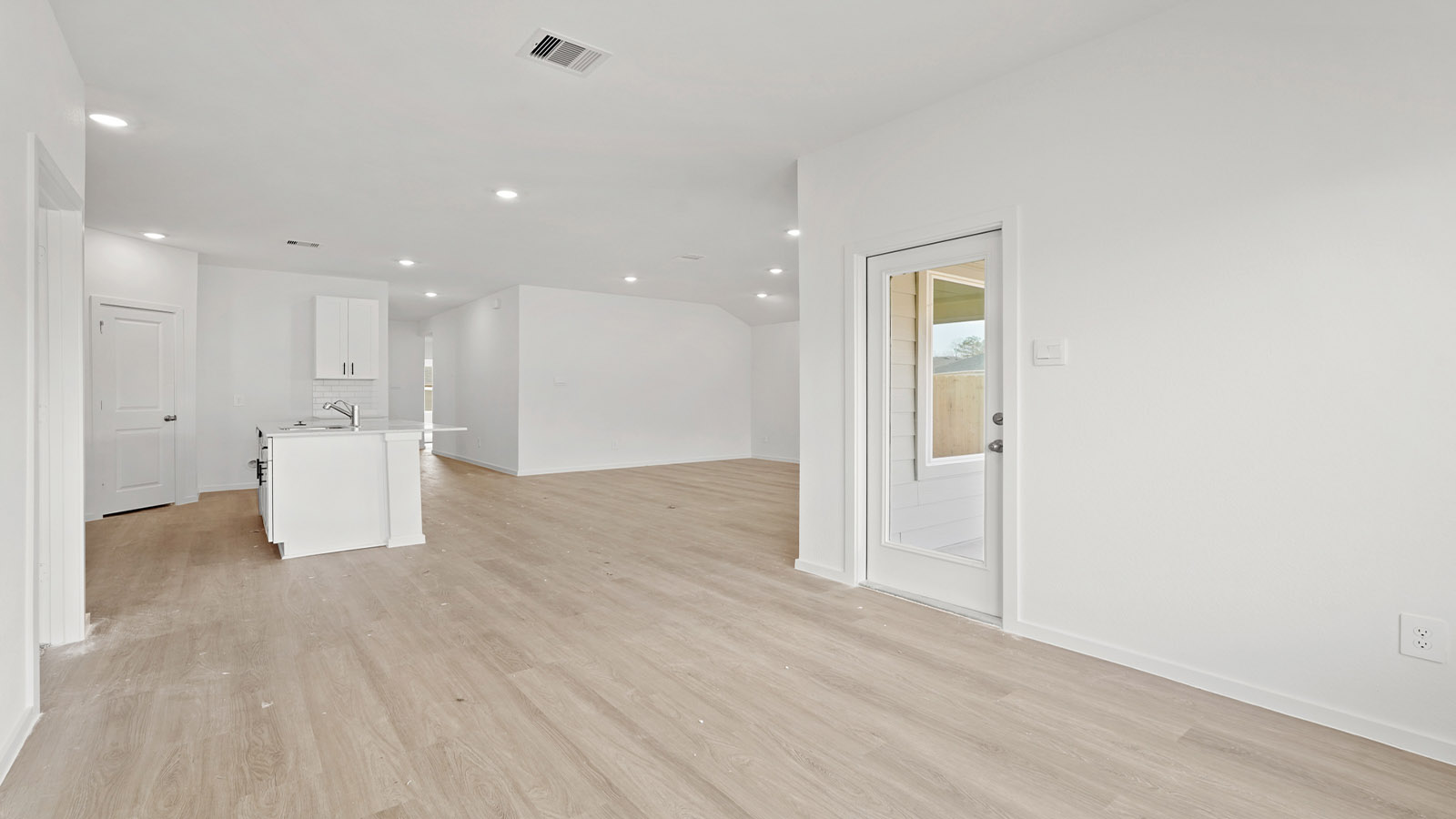 open concept living and dining area with vinyl flooring and quartz countertops