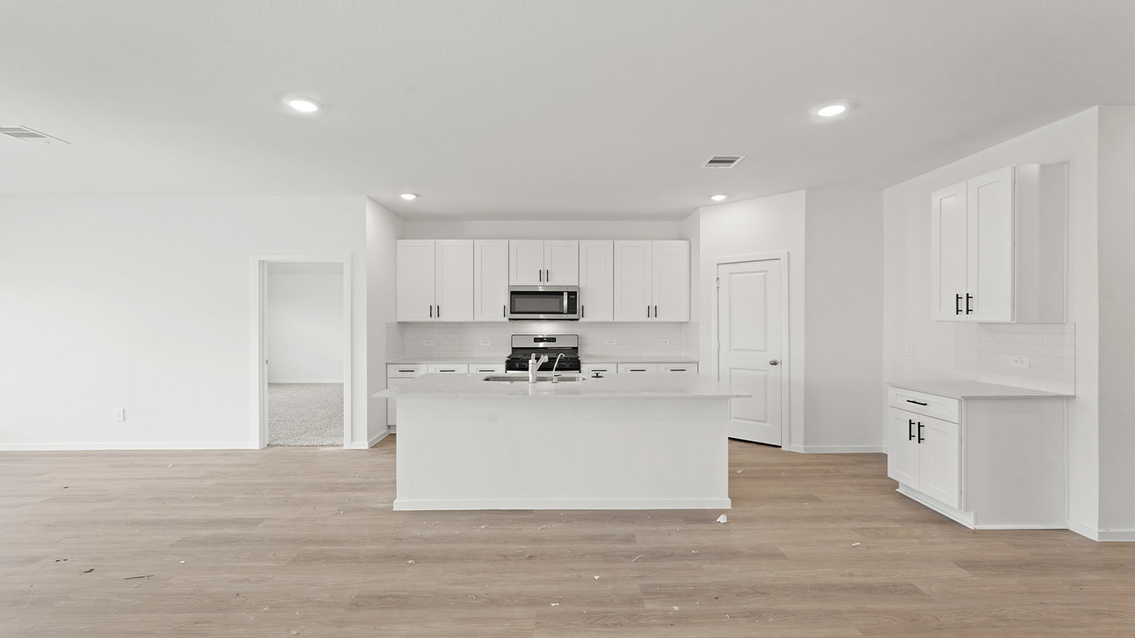 open concept living and dining area with vinyl flooring and quartz countertops
