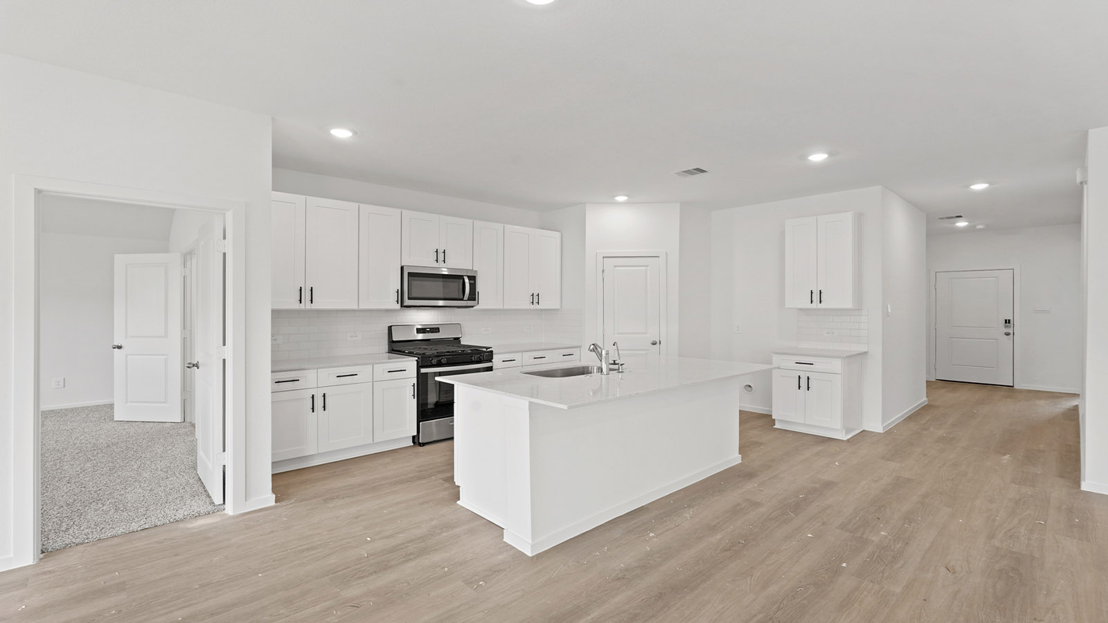 open concept living and dining area with vinyl flooring and quartz countertops