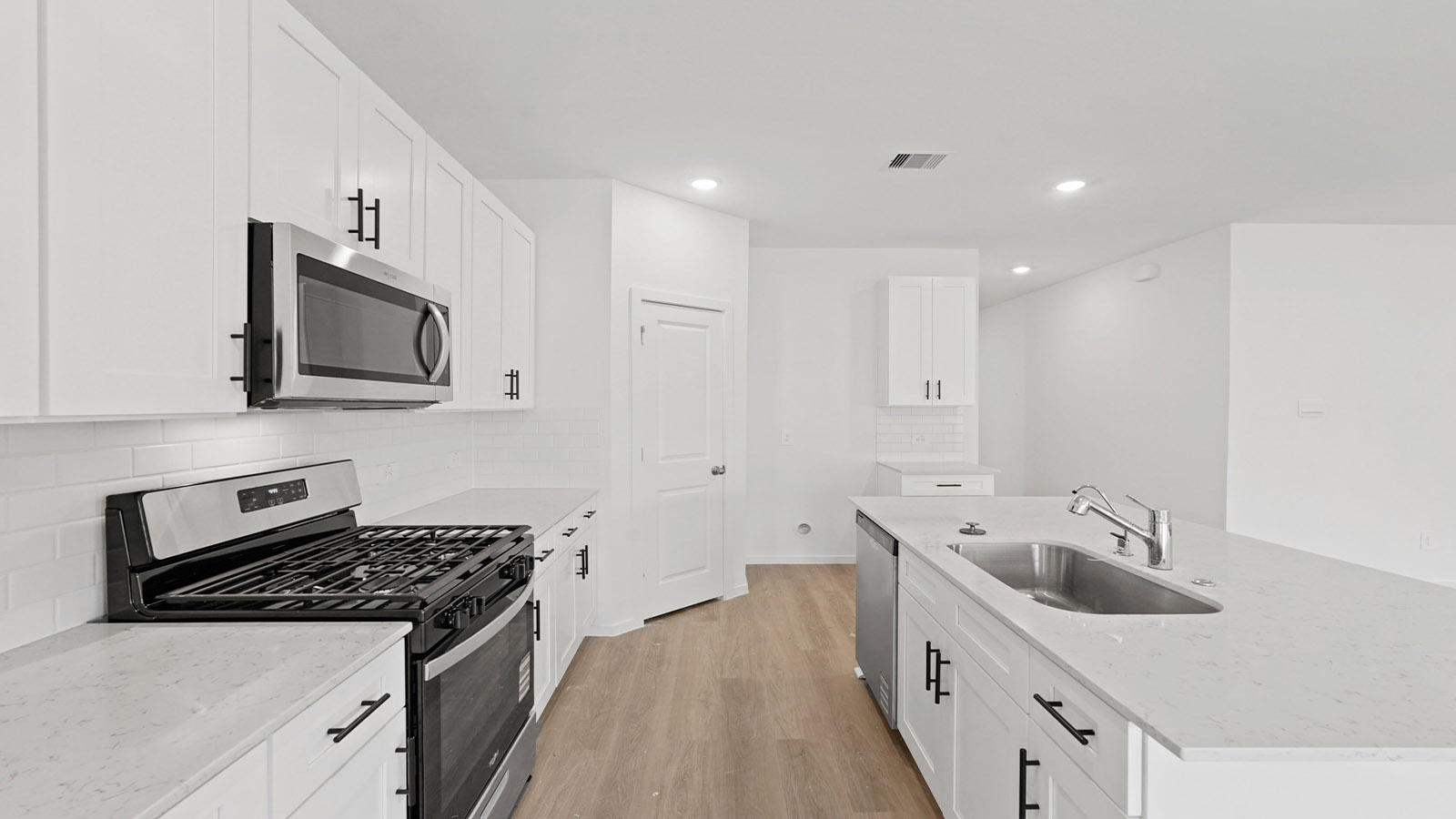 open concept living and dining area with vinyl flooring and quartz countertops