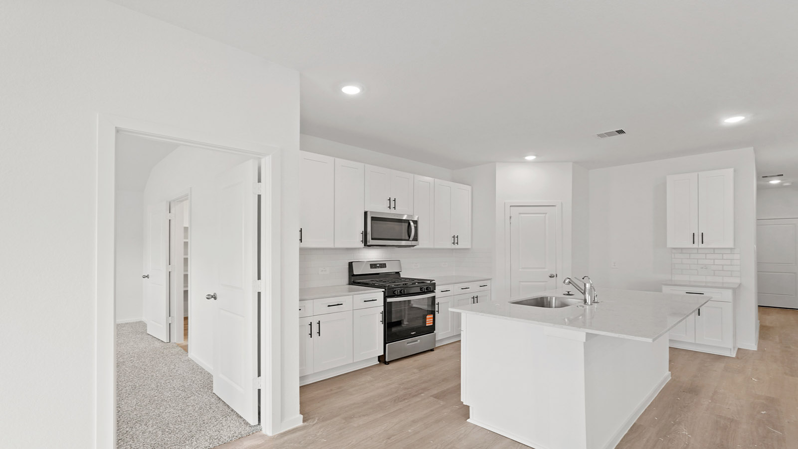 open concept living and dining area with vinyl flooring and quartz countertops