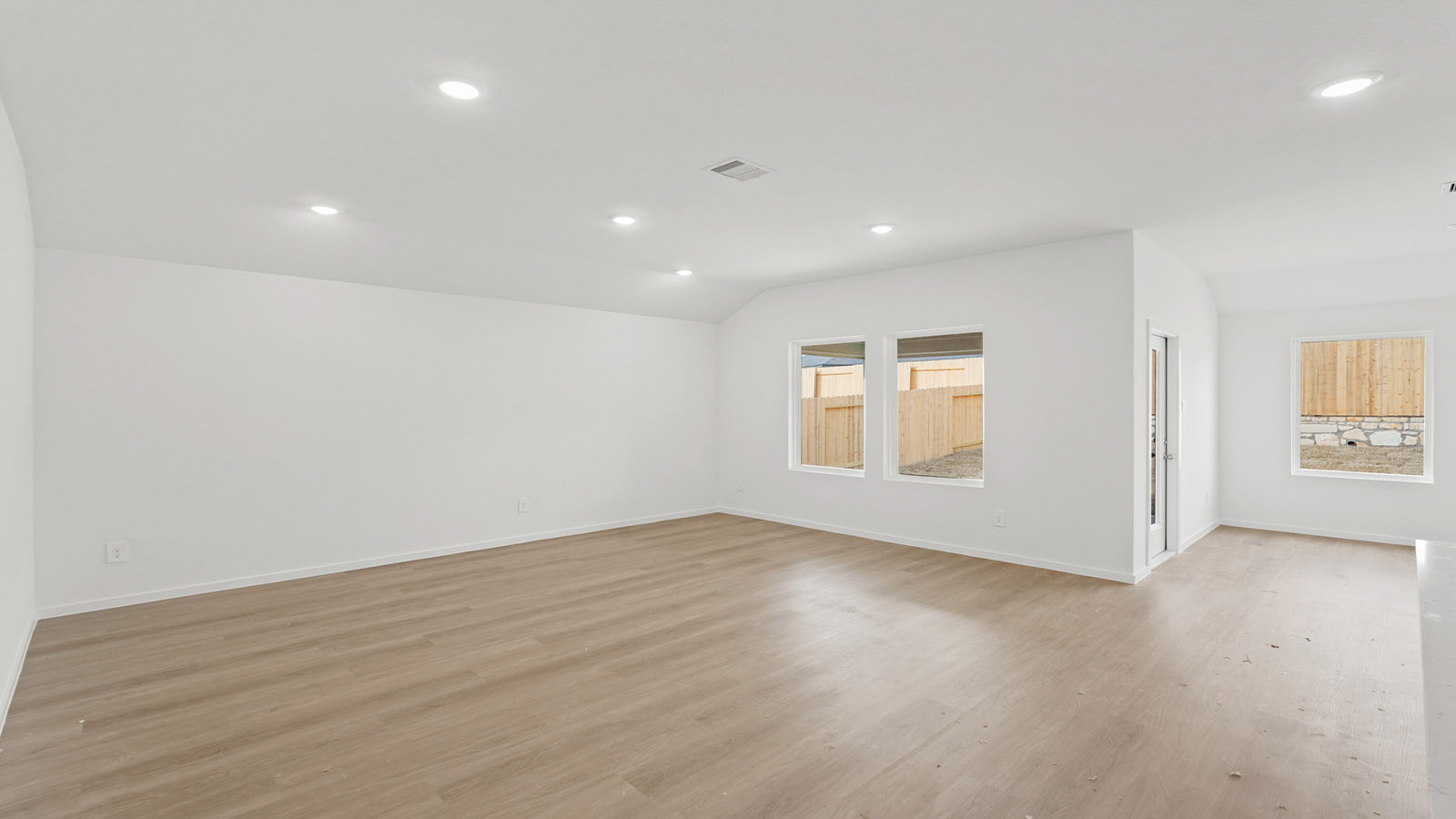 open concept living and dining area with vinyl flooring and quartz countertops