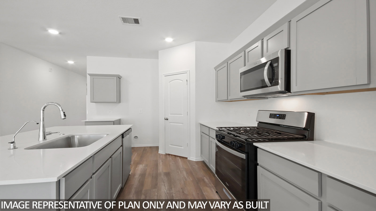 open concept living and dining area with vinyl flooring, quartz countertops, and stainless steel appliances in Magnolia, TX