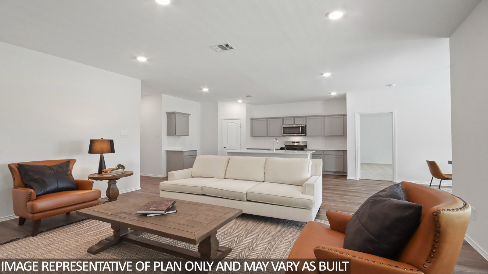open concept living and dining area with vinyl flooring, quartz countertops, and stainless steel appliances in Magnolia, TX