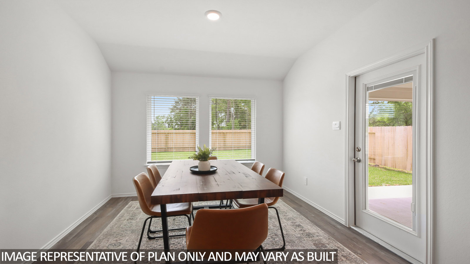 open concept living and dining area with vinyl flooring, quartz countertops, and stainless steel appliances in Magnolia, TX
