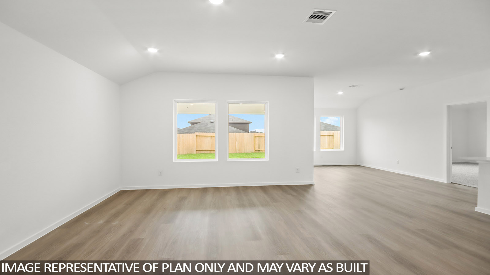 open concept living and dining area with vinyl flooring, large windows, and quartz countertops