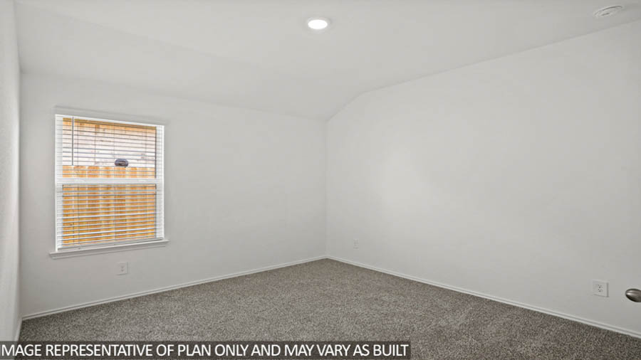 Secondary bedroom with carpet flooring