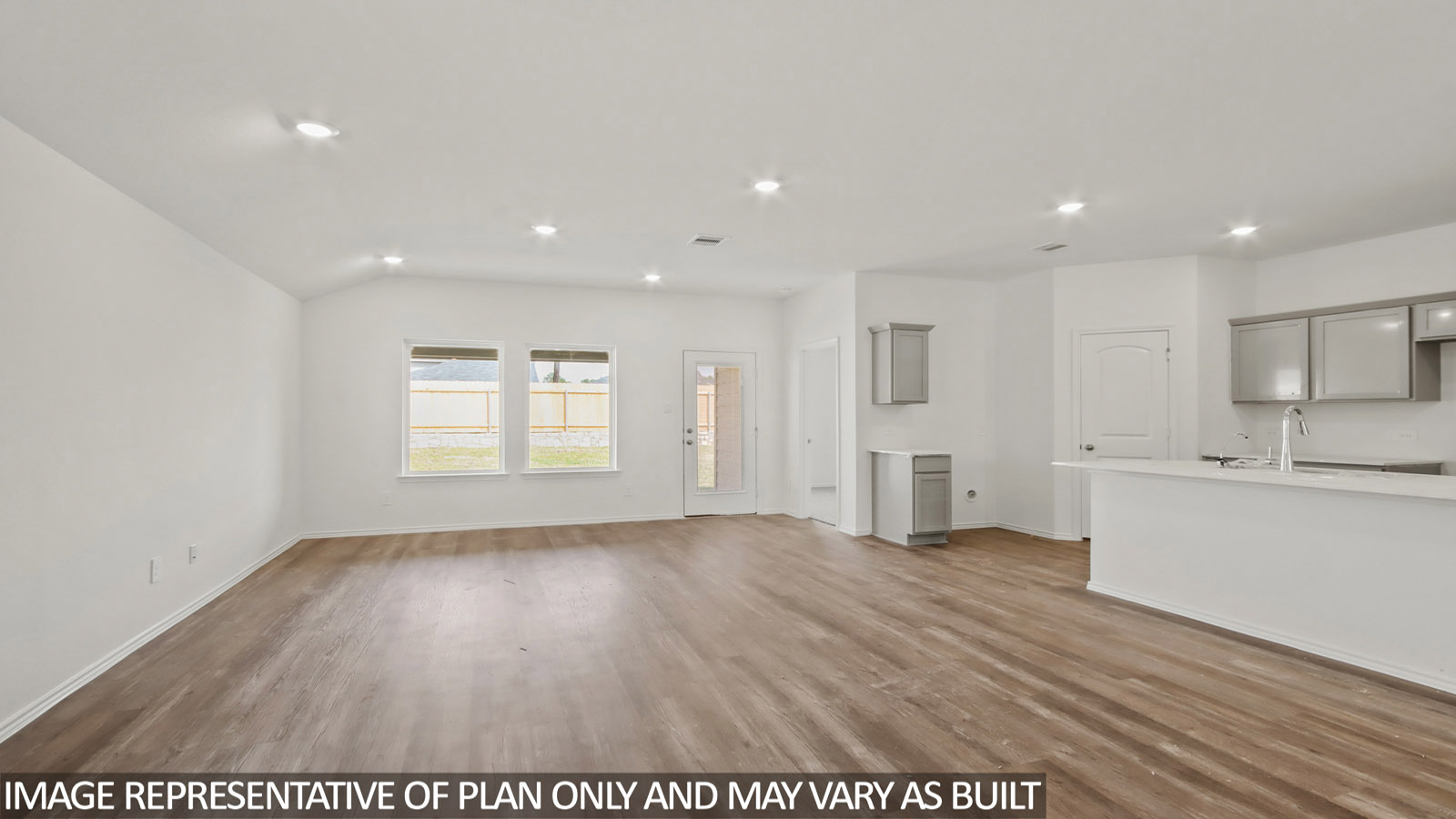 open concept living and dining area with vinyl flooring, large windows, and quartz countertops