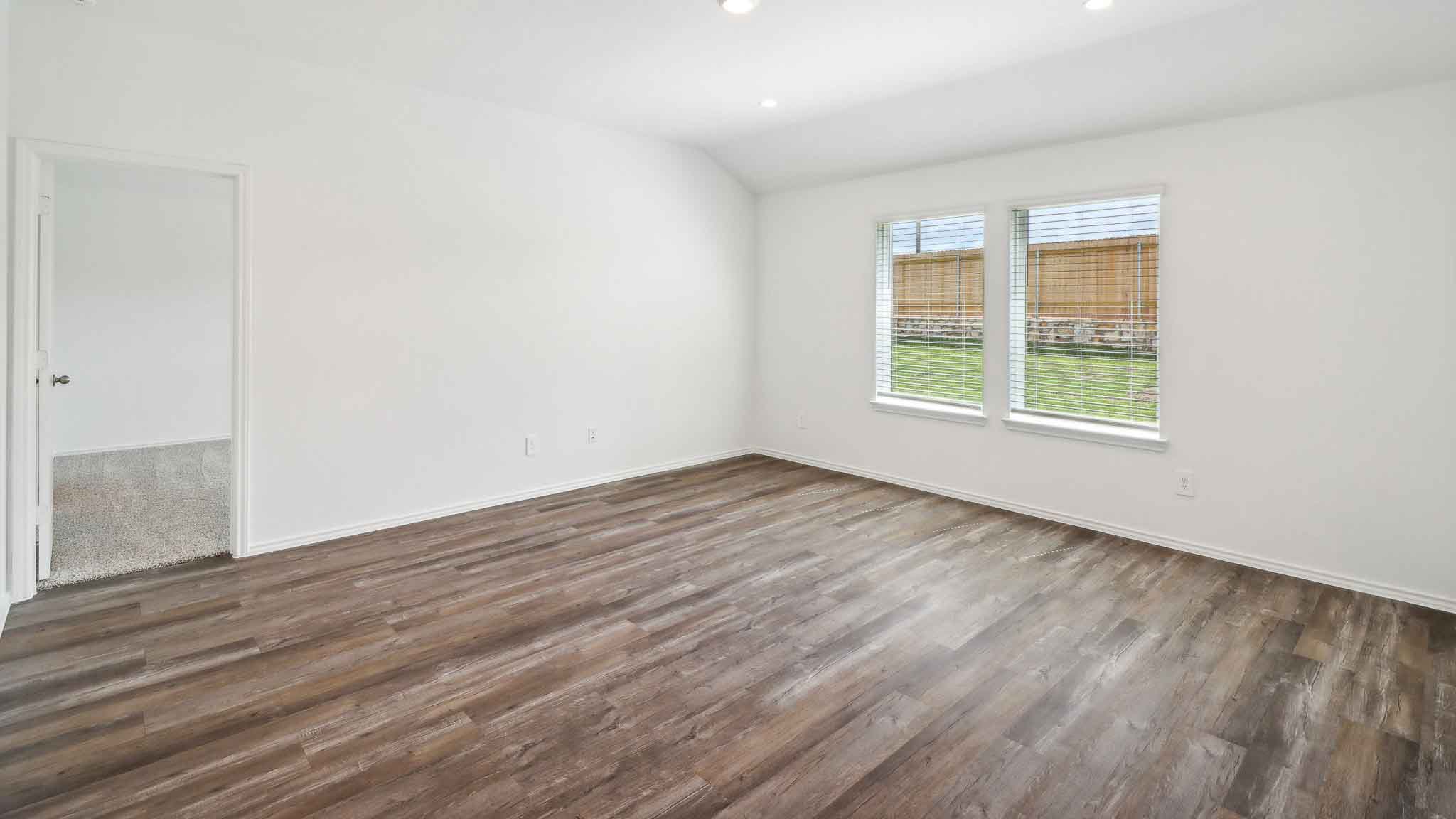 open concept living and dining area with vinyl flooring, quartz countertops, and stainless steel appliances