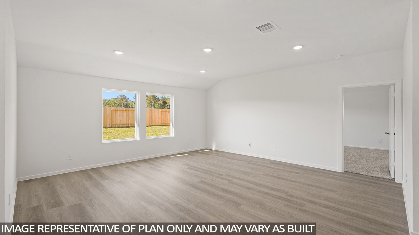 open concept living and dining area with vinyl flooring, large windows, and quartz countertops