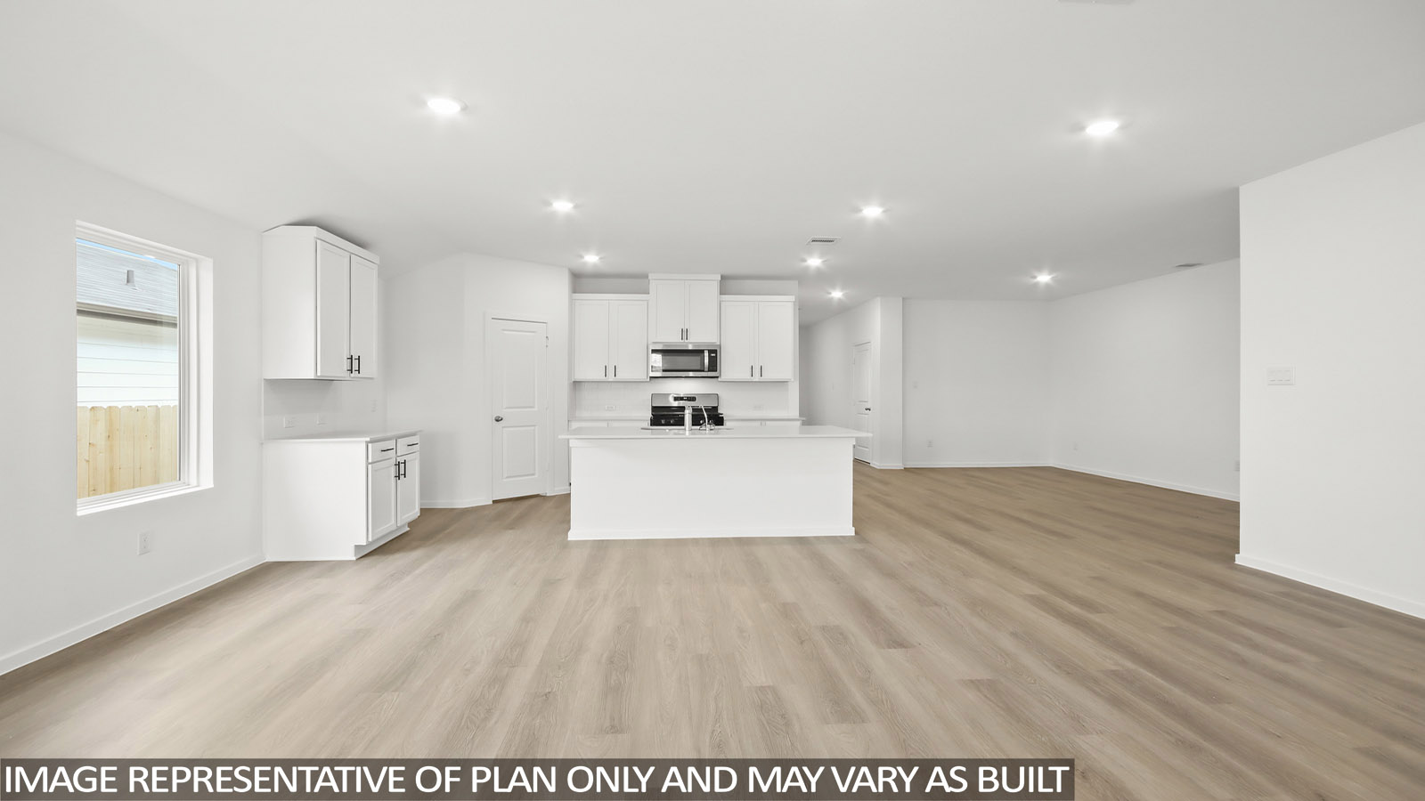 open concept living and dining area with vinyl flooring, large windows.