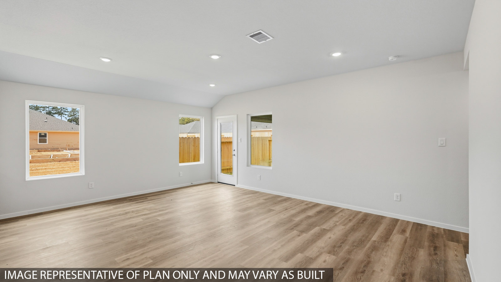 open concept living and dining area with large windows and vinyl flooring